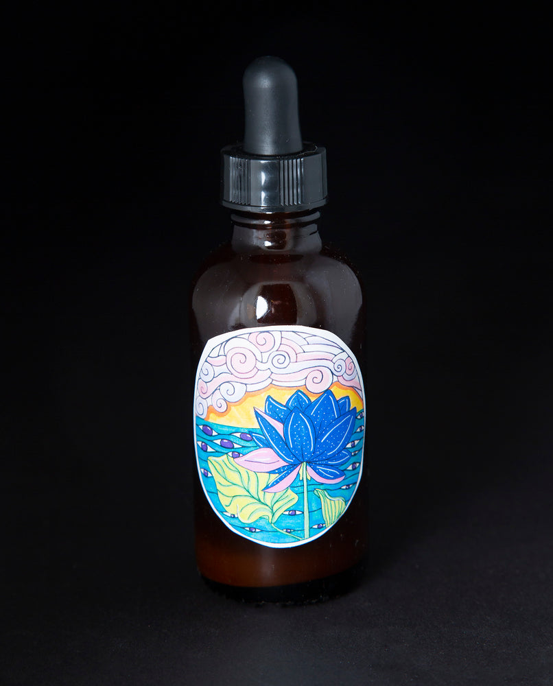 Back label of the blue lotus tincture featuring a colourful cartoonish illustration of a blue lotus flower and psychedelic visuals.