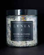 A clear 16 ounce jar filled with LVNEA's River Bathing bath salts on black background