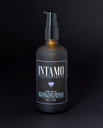 matte amber glass bottle with pump dispenser filled with Intamo's "Start Me Up" intimate massage oil