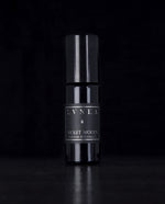 10ml black glass bottle of LVNEA's Violet Woods natural roll on perfume on black background