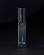 8ml clear glass bottle of LVNEA’s Les Lunatiques natural perfume on black background