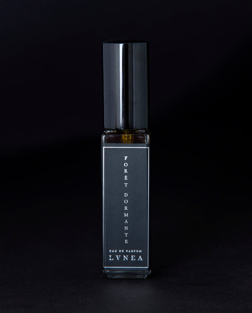 8ml clear glass bottle of LVNEA’s Forêt Dormante natural perfume on black background