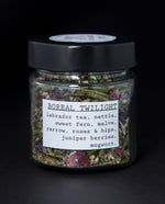 Clear glass jar with black lid filled with herbal tea blend. The label reads "Boreal Twilight"