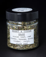 Clear glass jar with black lid containing "Heart & Cough Ease" herbal tea blend by blueberryjams.