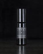 10ml black glass bottle of LVNEA's Fern and Moss natural roll on perfume oil on black background