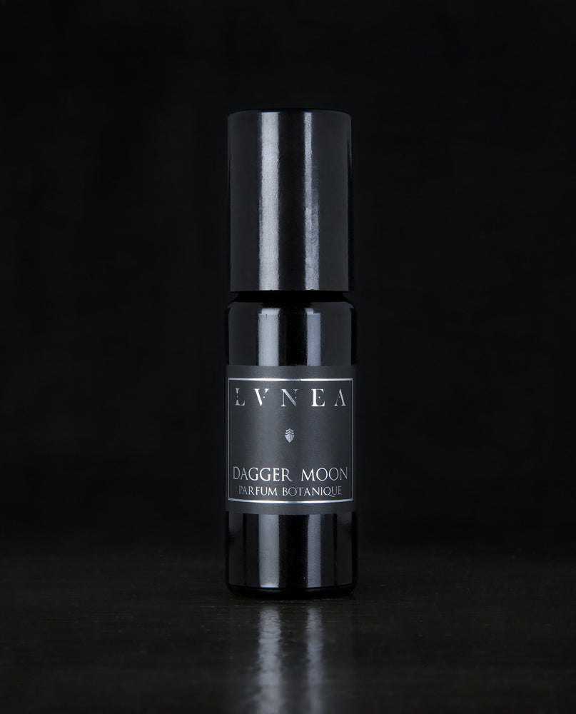 10ml black glass bottle of LVNEA's Dagger Moon natural roll on perfume oil on black background