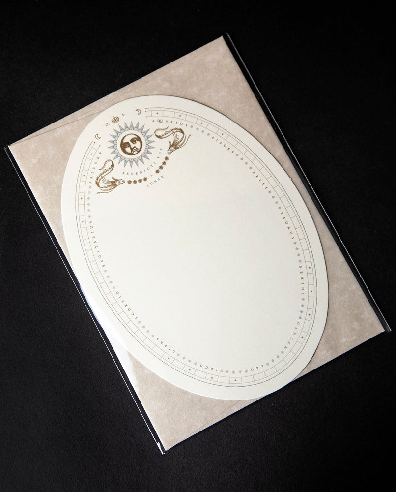 white oval greeting card with illustration of sun and ornamental detailing