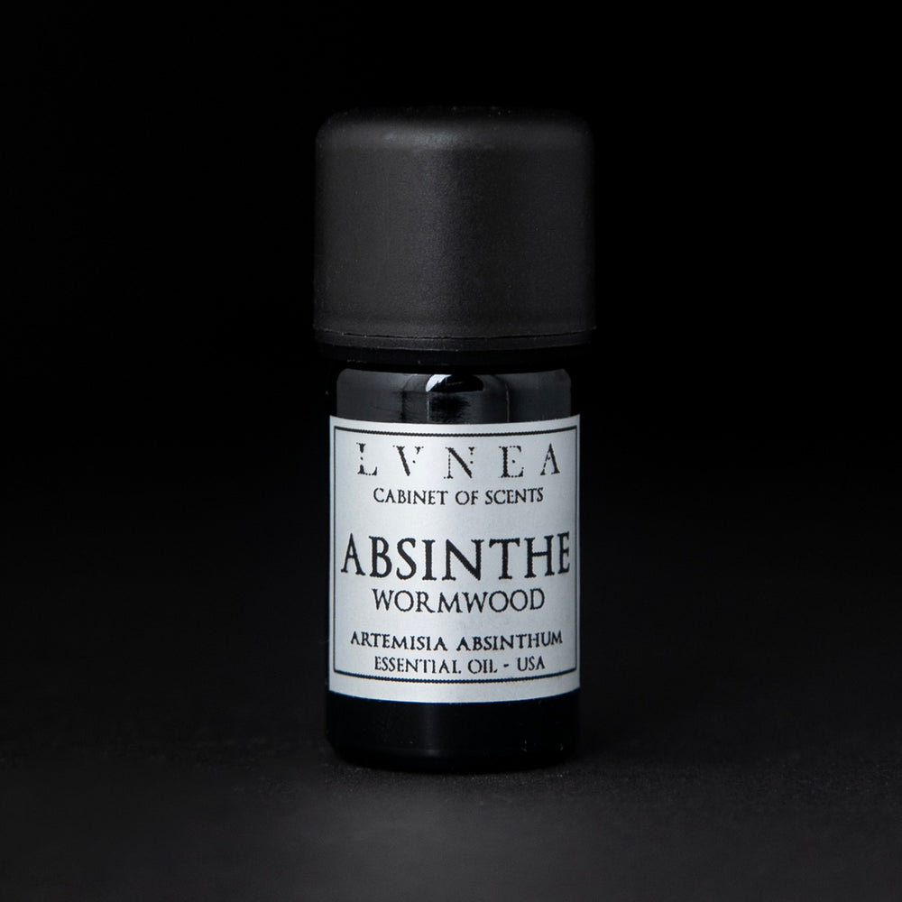 5ml black glass bottle with silver label of LVNEA's absinthe essential oil on black background.