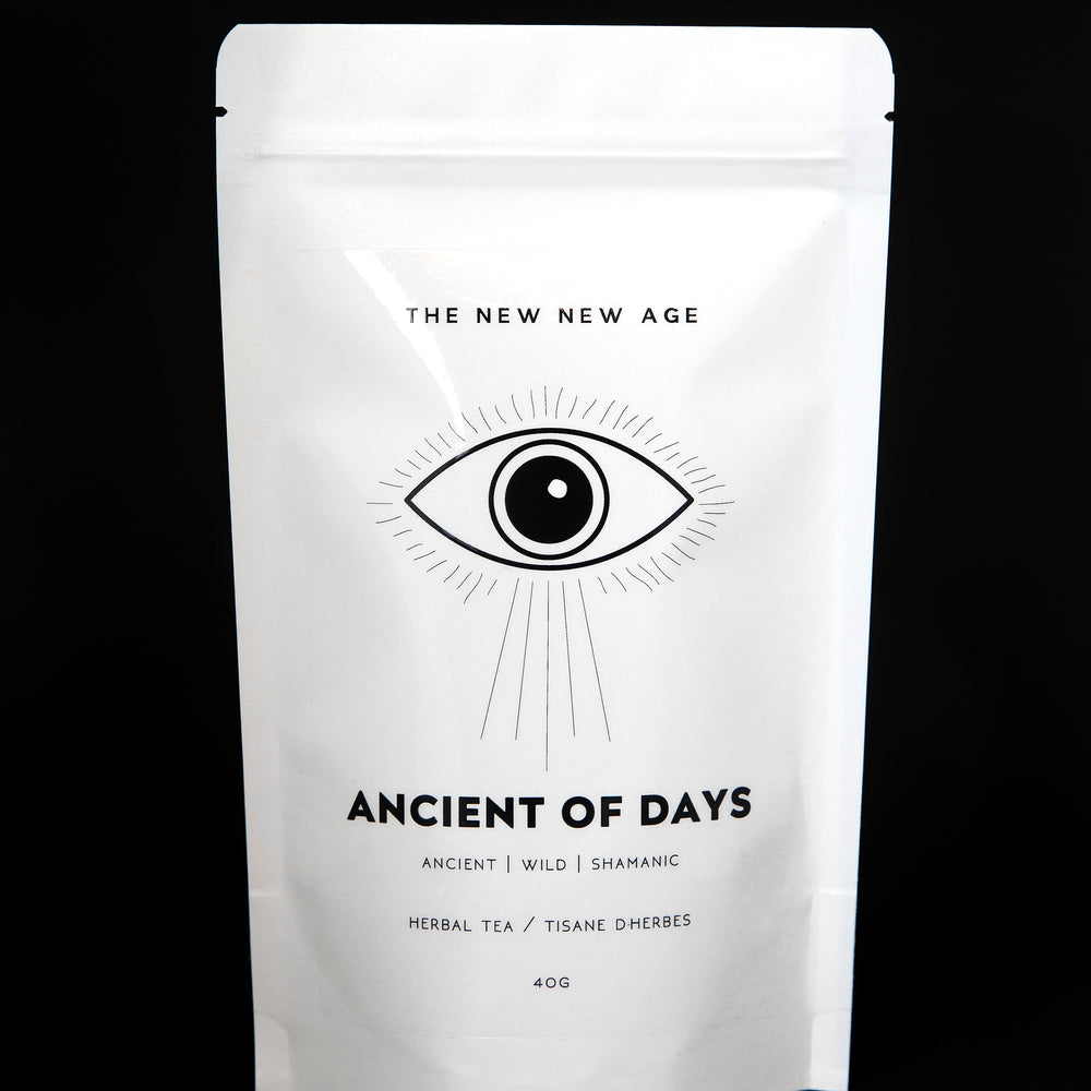White 40g resealable bag of The New New Age's "Ancient of Days" tea blend. There is a simple black illustration of an eye on the bag.