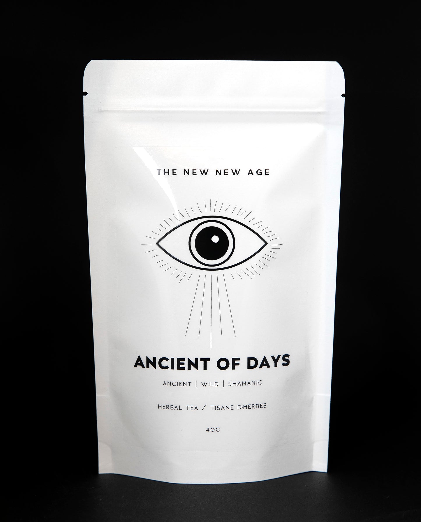 White 40g resealable bag of The New New Age's "Ancient of Days" tea blend. There is a simple black illustration of an eye on the bag.
