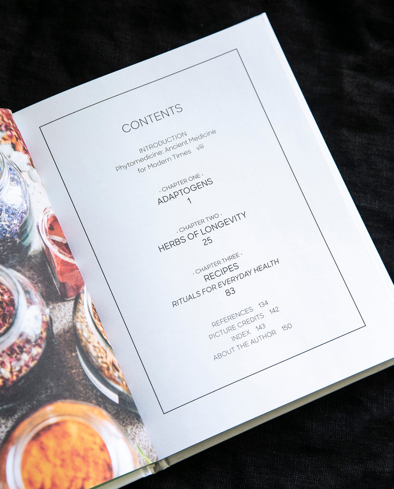Adriana Ayales' book "Adaptogens" open on the table of contents page.