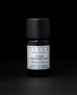 5ml black glass bottle with silver label of LVNEA's atlas cedarwood essential oil on black background
