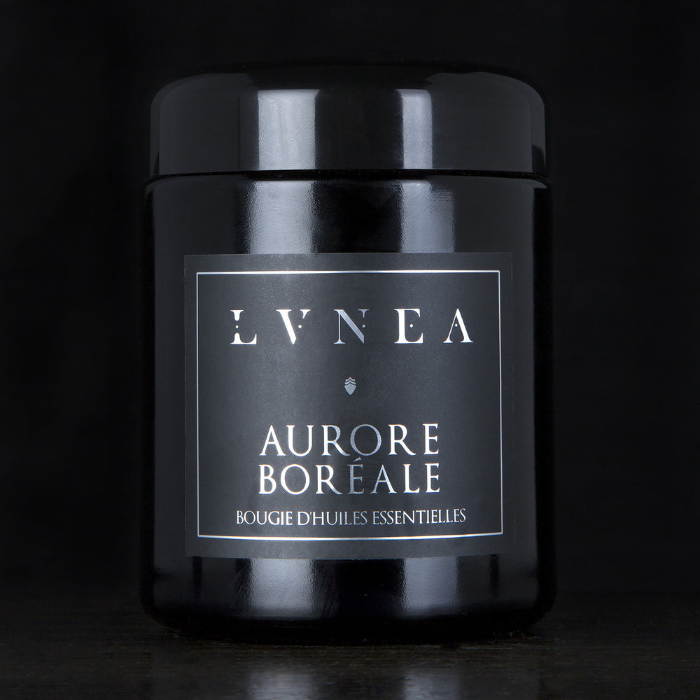 LVNEA’s Aurore Boréale candle housed in a resealable 8 ounce black glass jar on a black background