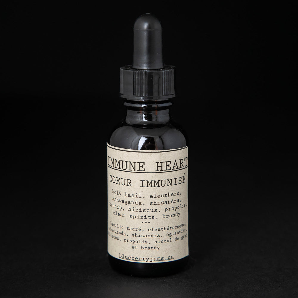 Black glass bottle with dropper top of blueberryjams "Immune Heart" herbal tincture.