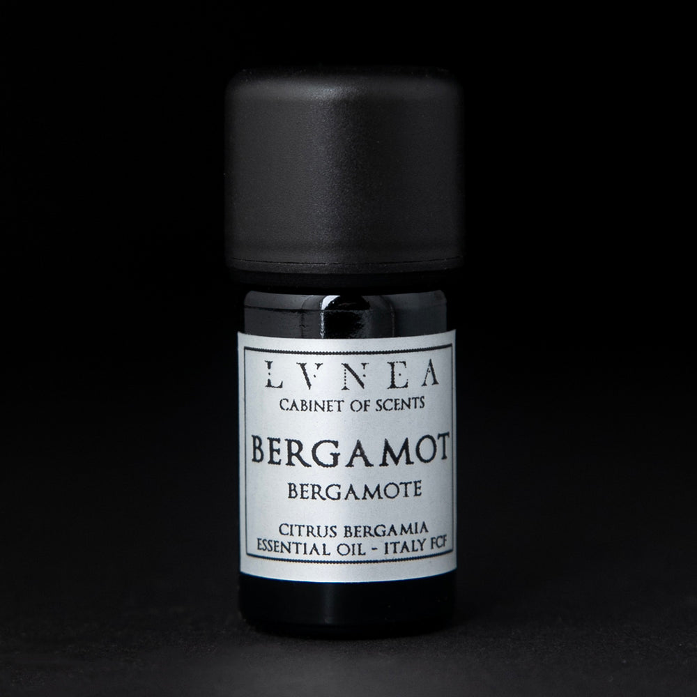 5ml black glass bottle with silver label of LVNEA's bergamot essential oil on black background