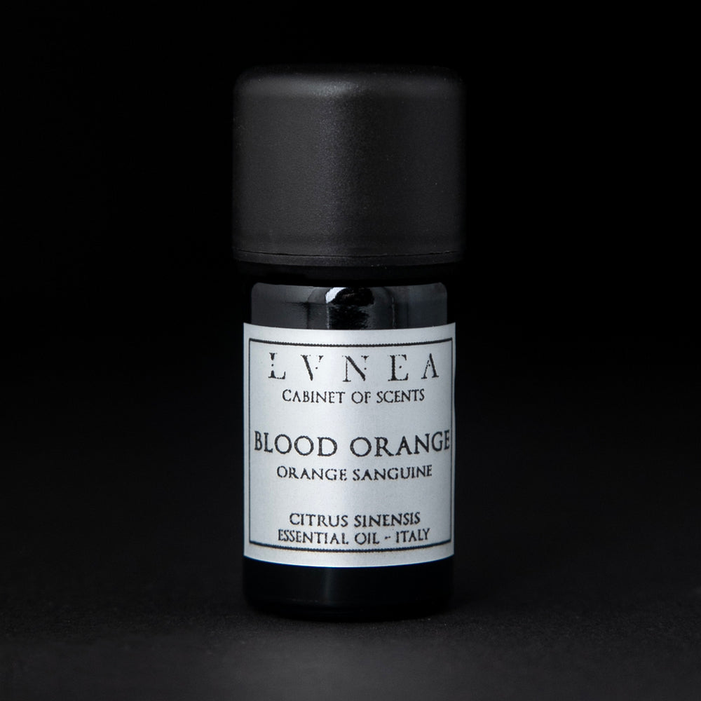5ml black glass bottle of LVNEA's blood orange essential oil on black background. The bottle has a silver label.