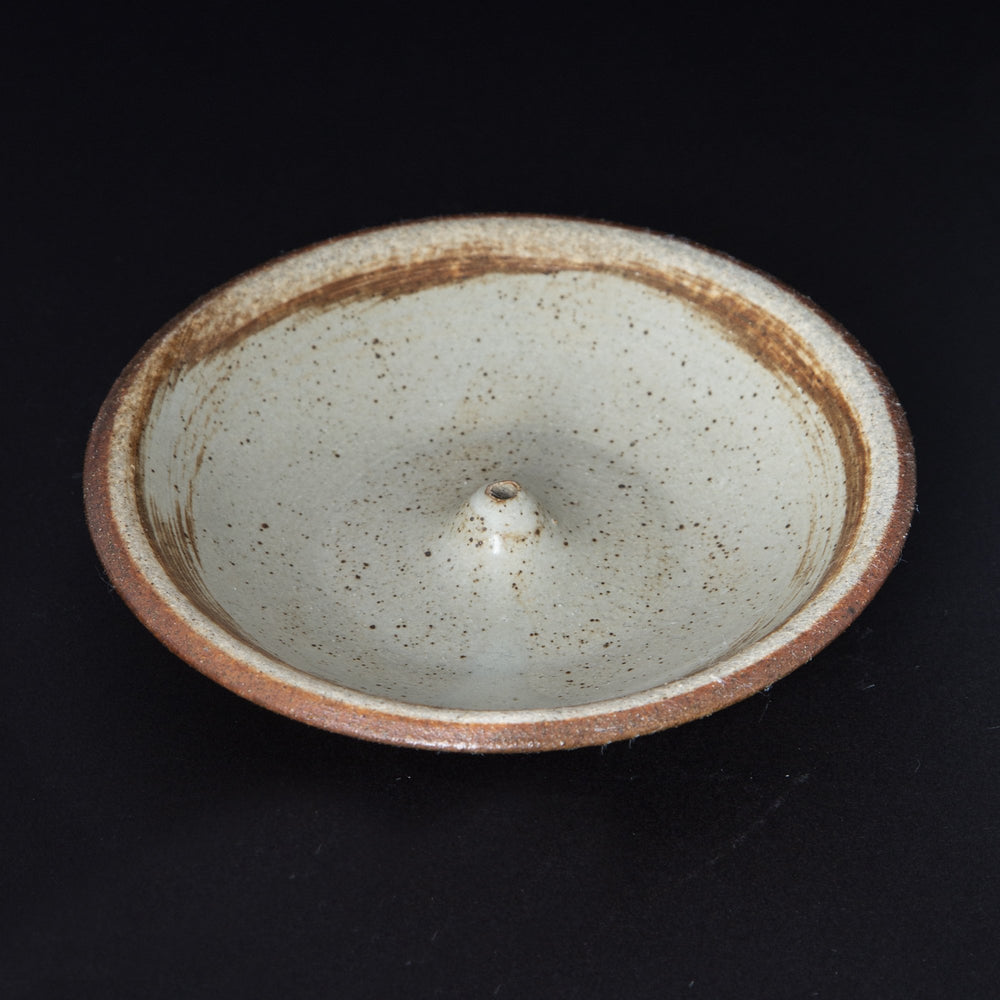 
                      
                        cream coloured glazed stoneware incense holder on black background
                      
                    