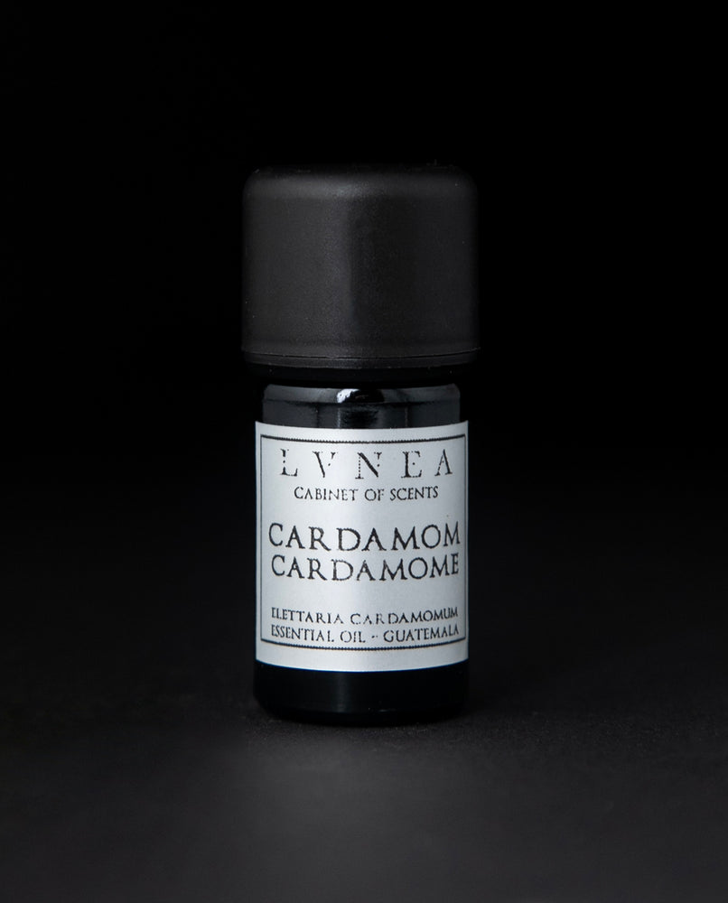 5ml black glass bottle with silver label of LVNEA's cardamom essential oil on black background