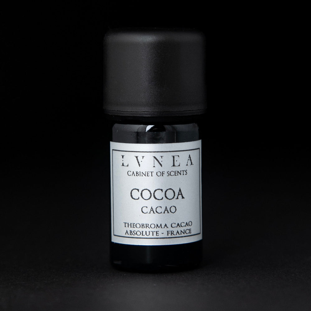5ml black glass bottle with silver label of LVNEA's cocoa absolute on black background
