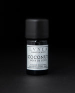 5ml black glass bottle with silver label of LVNEA's coconut essential oil on black background