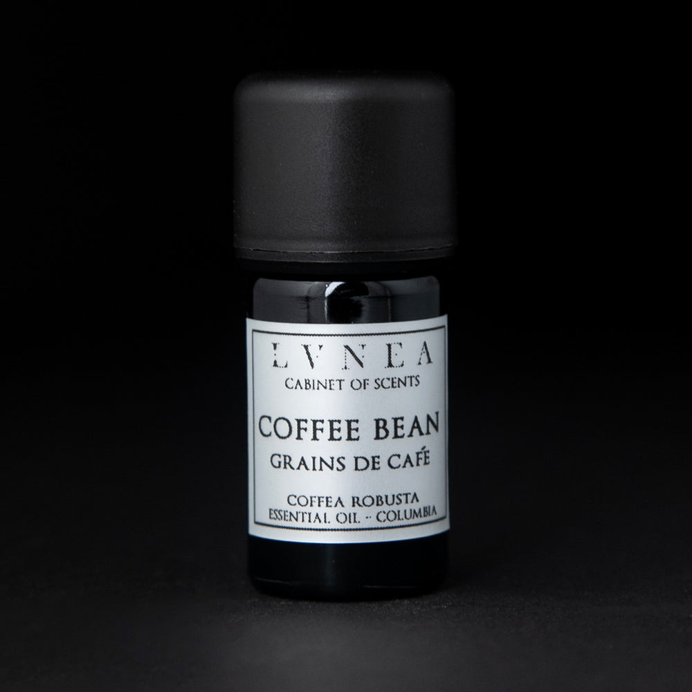 5ml black glass bottle with silver label of LVNEA's coffee bean essential oil on black background