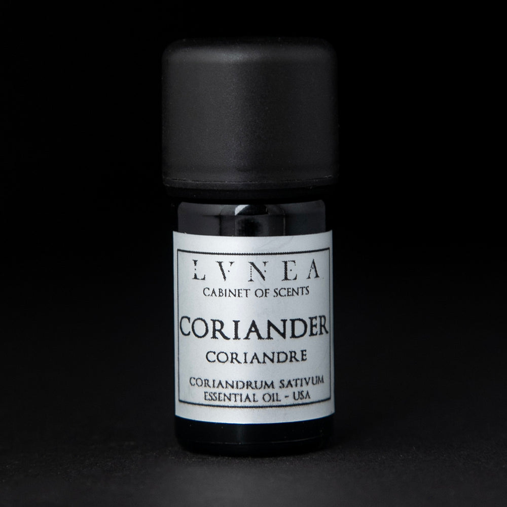 5ml black glass bottle with silver label of LVNEA's coriander essential oil on black background