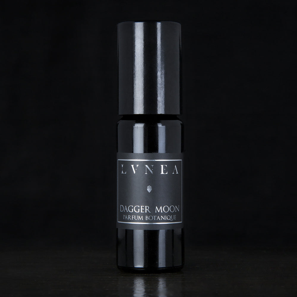 10ml black glass bottle of LVNEA's Dagger Moon natural roll on perfume oil on black background