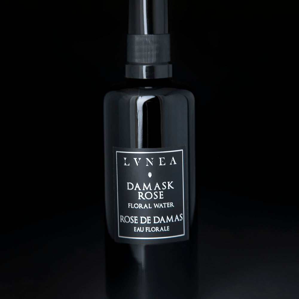 100ml black glass bottle of LVNEA's Damask Rose Hydrosol on black background