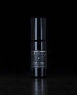 10ml black glass bottle of LVNEA's Nuit Désert natural roll on perfume on black background