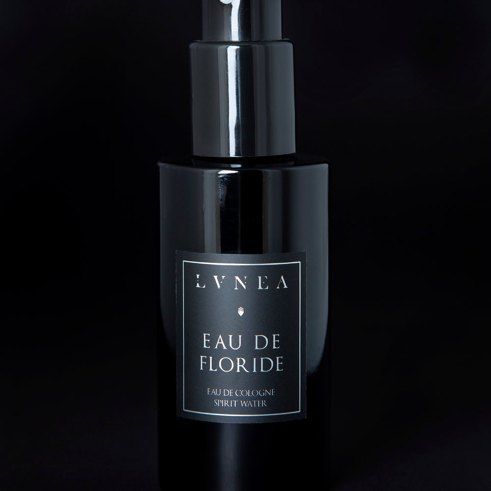 100ml black glass bottle of LVNEA’s Eau de Floride natural fragrance on black background