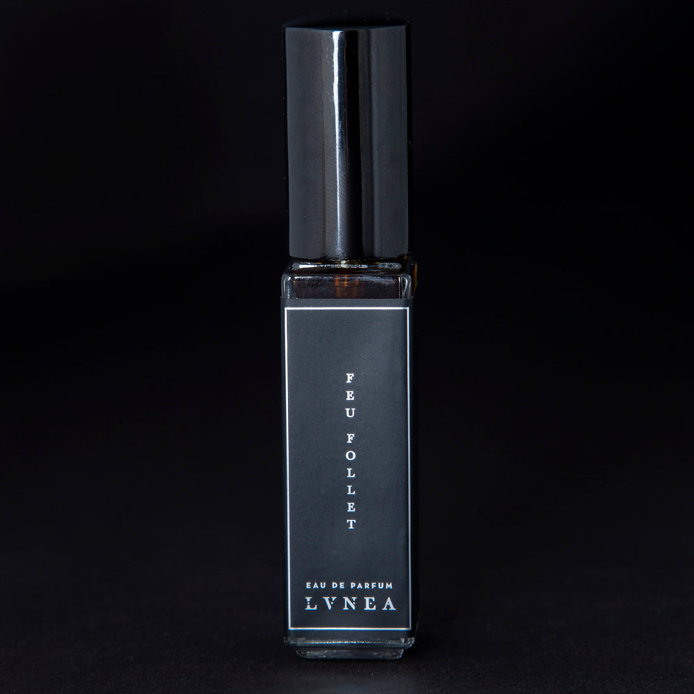 8ml clear glass bottle of LVNEA’s Feu Follet natural perfume on black background