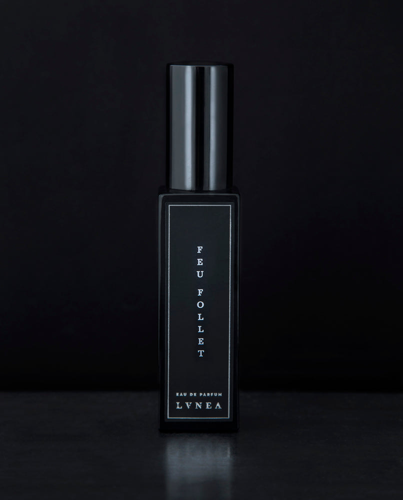 30ml black glass bottle of LVNEA’s Feu Follet natural perfume on black background