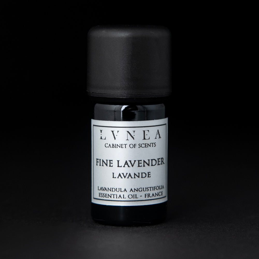 5ml black glass bottle of LVNEA's lavender essential oil on black background. The label on the bottle is silver.