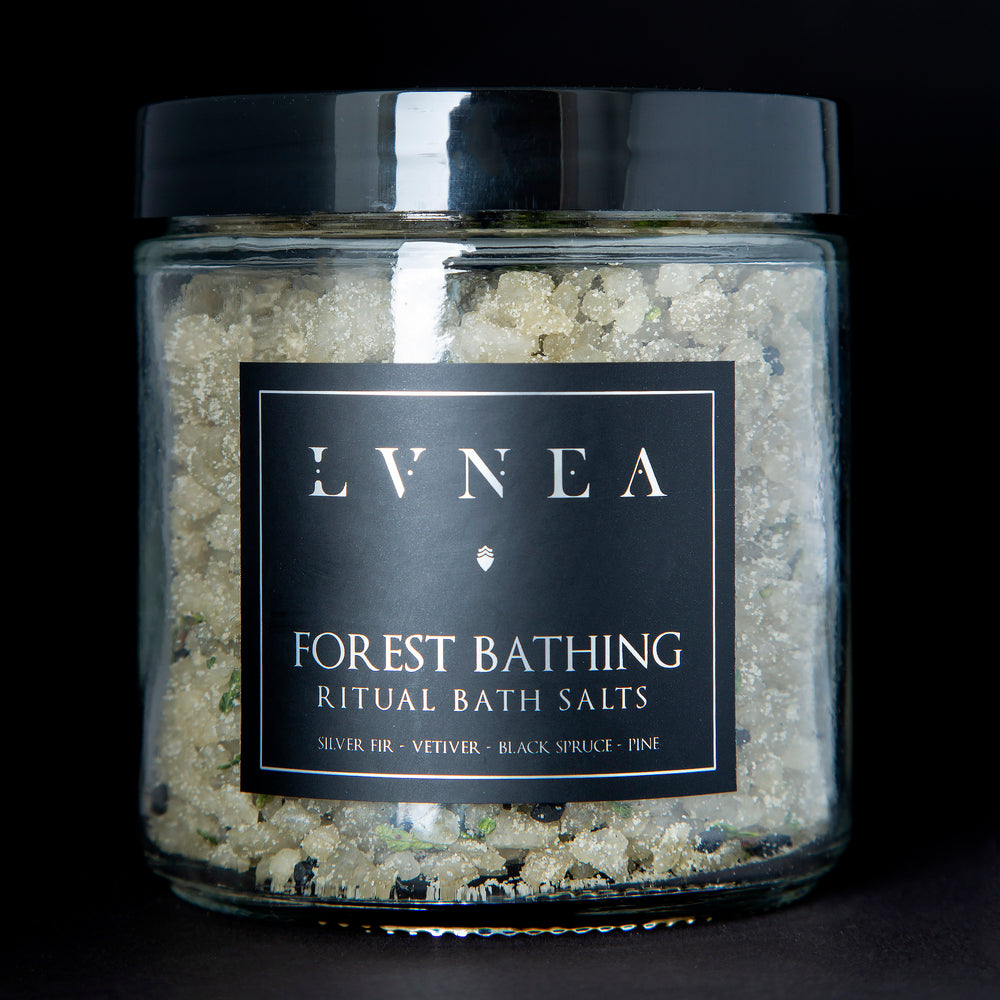 
                      
                        A clear 16 ounce jar filled with LVNEA's Forest Bathing bath salts on black background
                      
                    