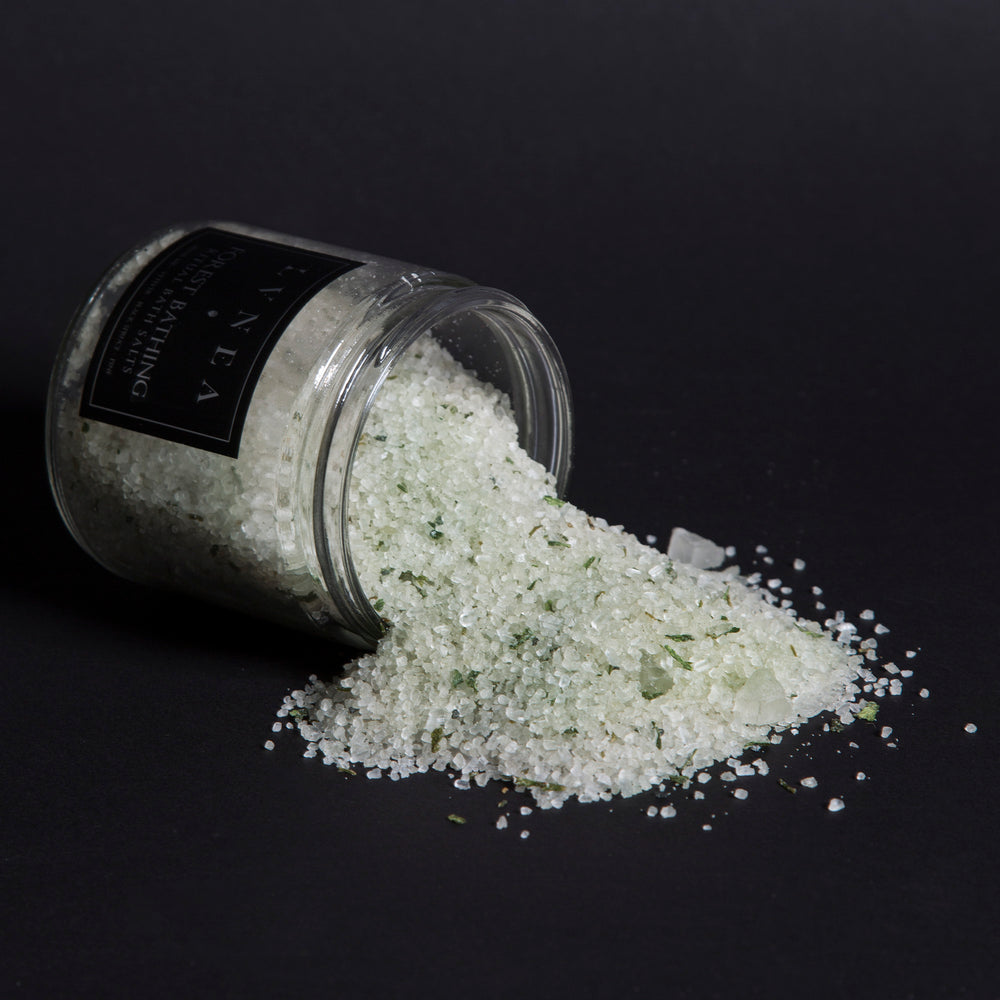 
                      
                        LVNEA'S Forest Bathing bath salts spilling out of a tipped over 16 ounce clear glass jar
                      
                    