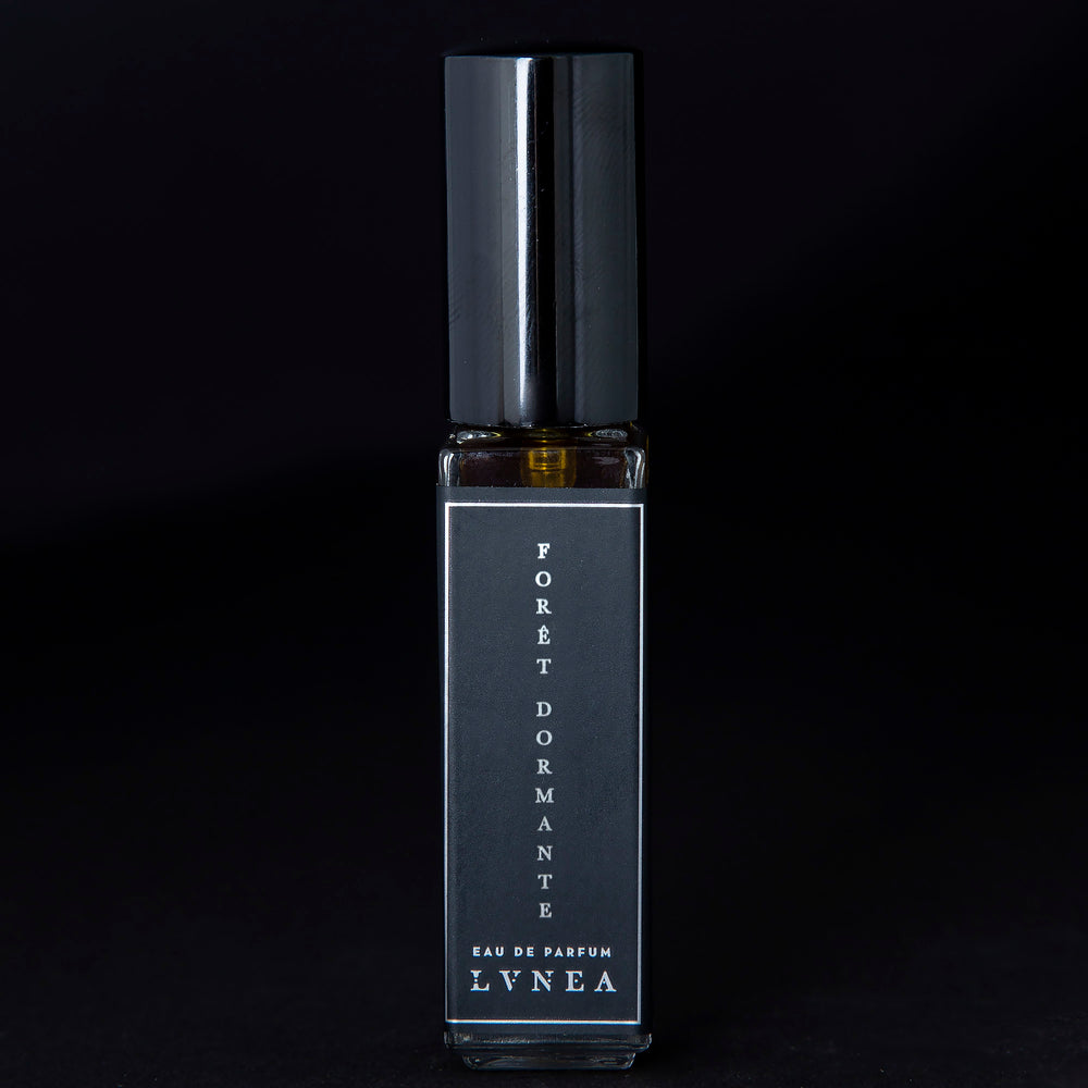 8ml clear glass bottle of LVNEA’s Forêt Dormante natural perfume on black background