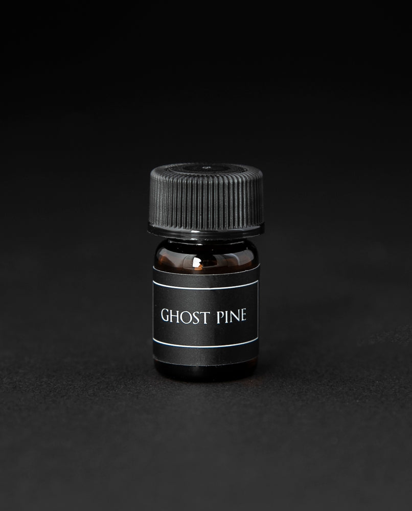 1.25ml glass sample vial of LVNEA's best selling natural fragrance Ghost Pine on black background