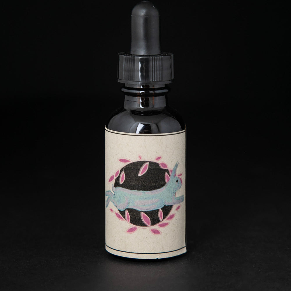 Black glass bottle with dropper top and tan label featuring an illustration of a rabbit. the bottle contains a herbal tincture by blueberryjams.