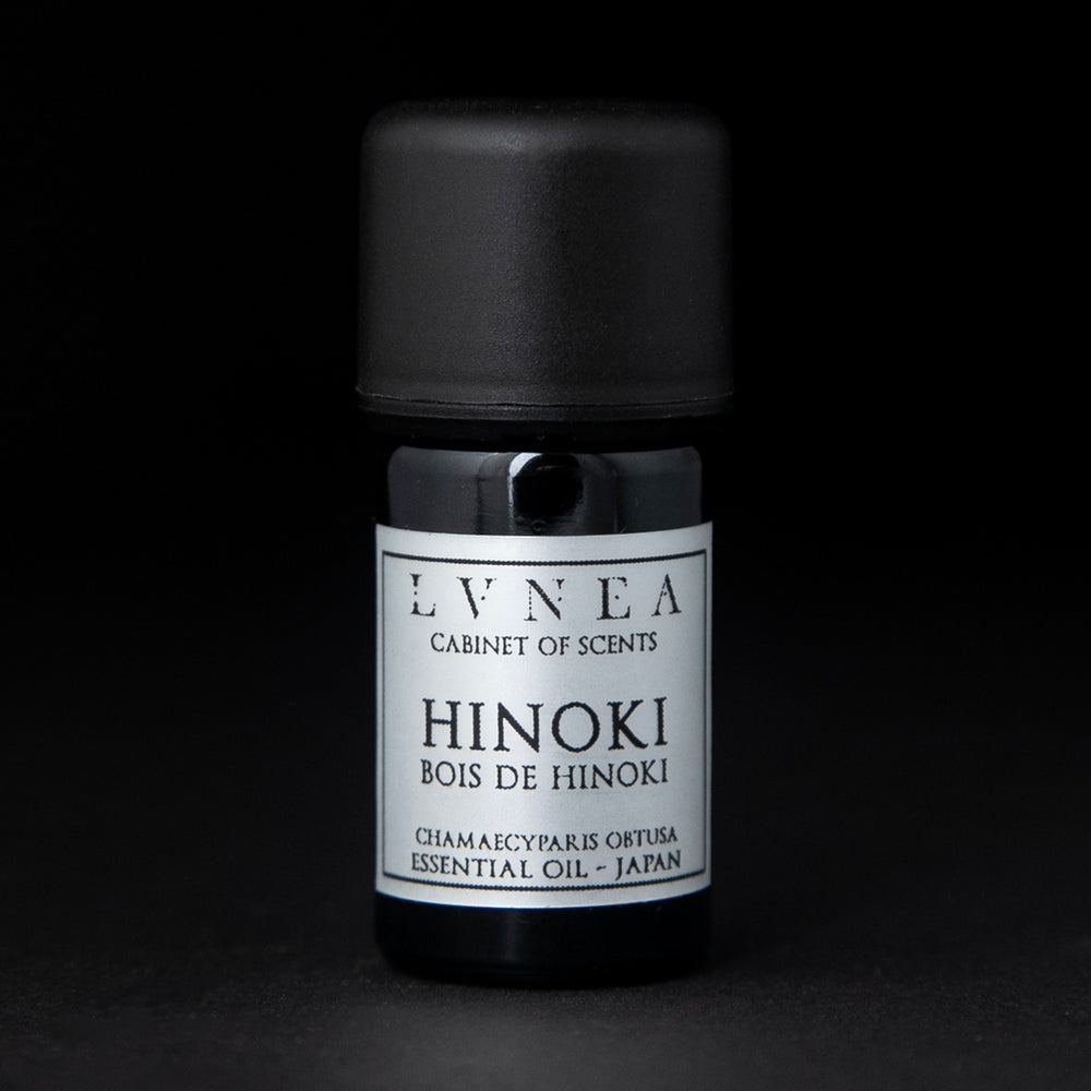 5ml black glass bottle of LVNEA's hinoki essential oil on black background. The label on the bottle is silver.