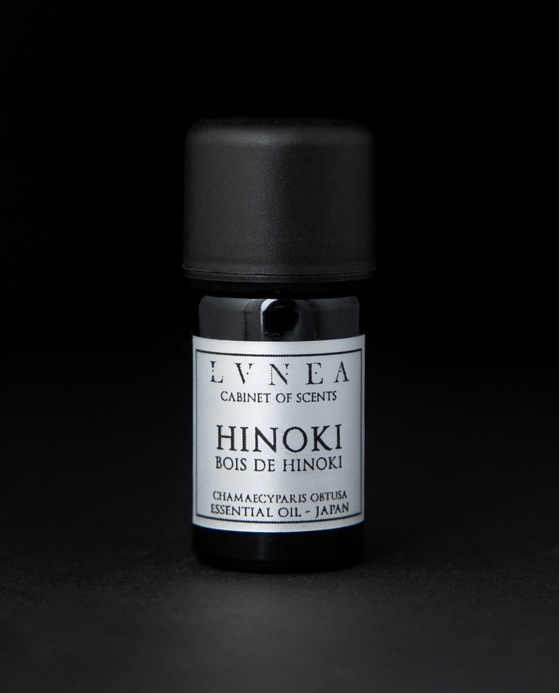 5ml black glass bottle of LVNEA's hinoki essential oil on black background. The label on the bottle is silver.