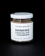 clear glass jar with white lid and white label filled with The New New Age's "Drinking Chocolate with Mushrooms"