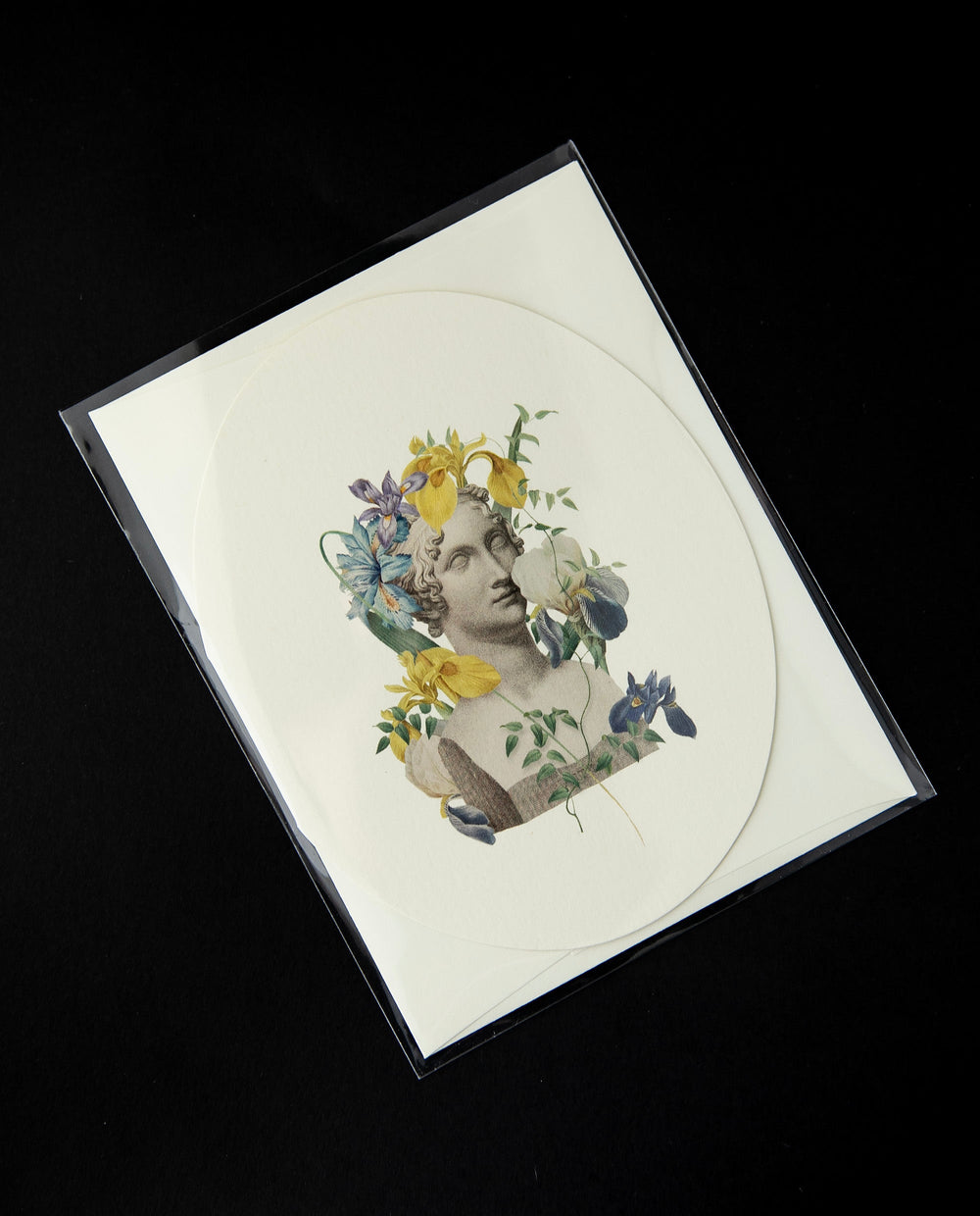 White oval-shaped card featuring a vintage Victorian-style illustration of a marble bust surrounded by irises.