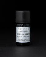 5ml black glass bottle of LVNEA's juniper berry essential oil on black background. The label on the bottle is silver.