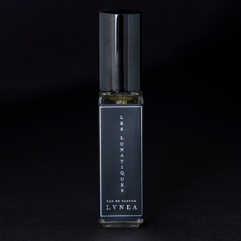 
                      
                        8ml clear glass bottle of LVNEA’s Les Lunatiques natural perfume on black background
                      
                    