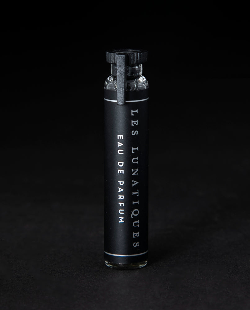 2ml glass sample vial of LVNEA's Les Lunatiques natural perfume on black background
