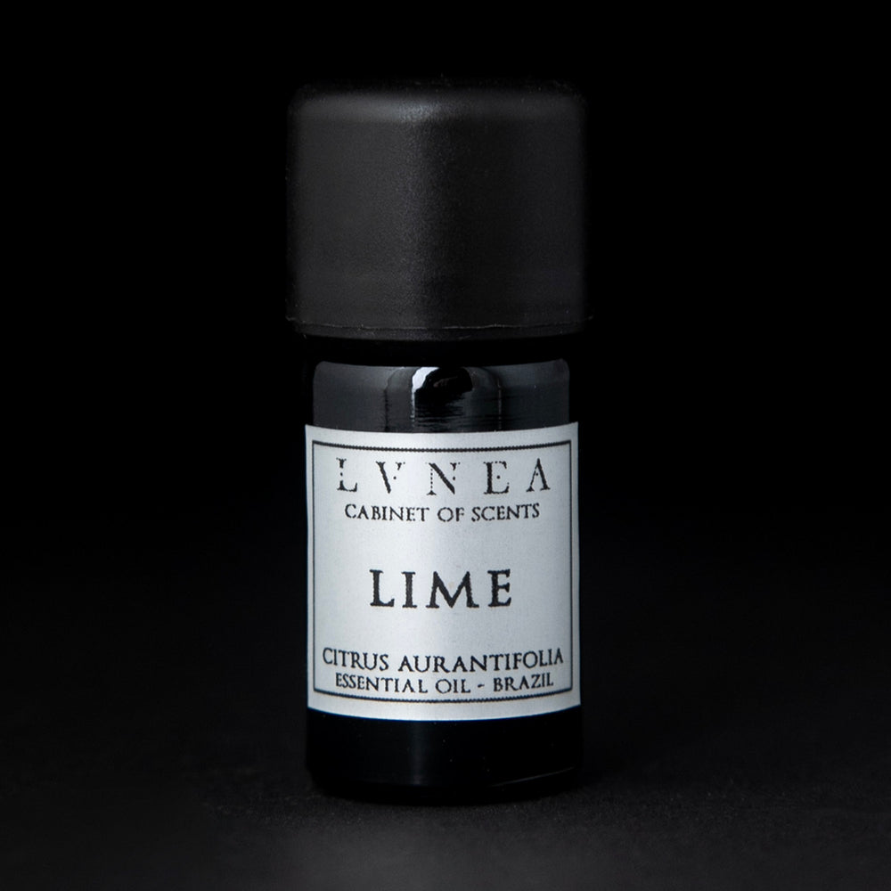 5ml black glass bottle of LVNEA's lime essential oil on black background. The label on the bottle is silver.