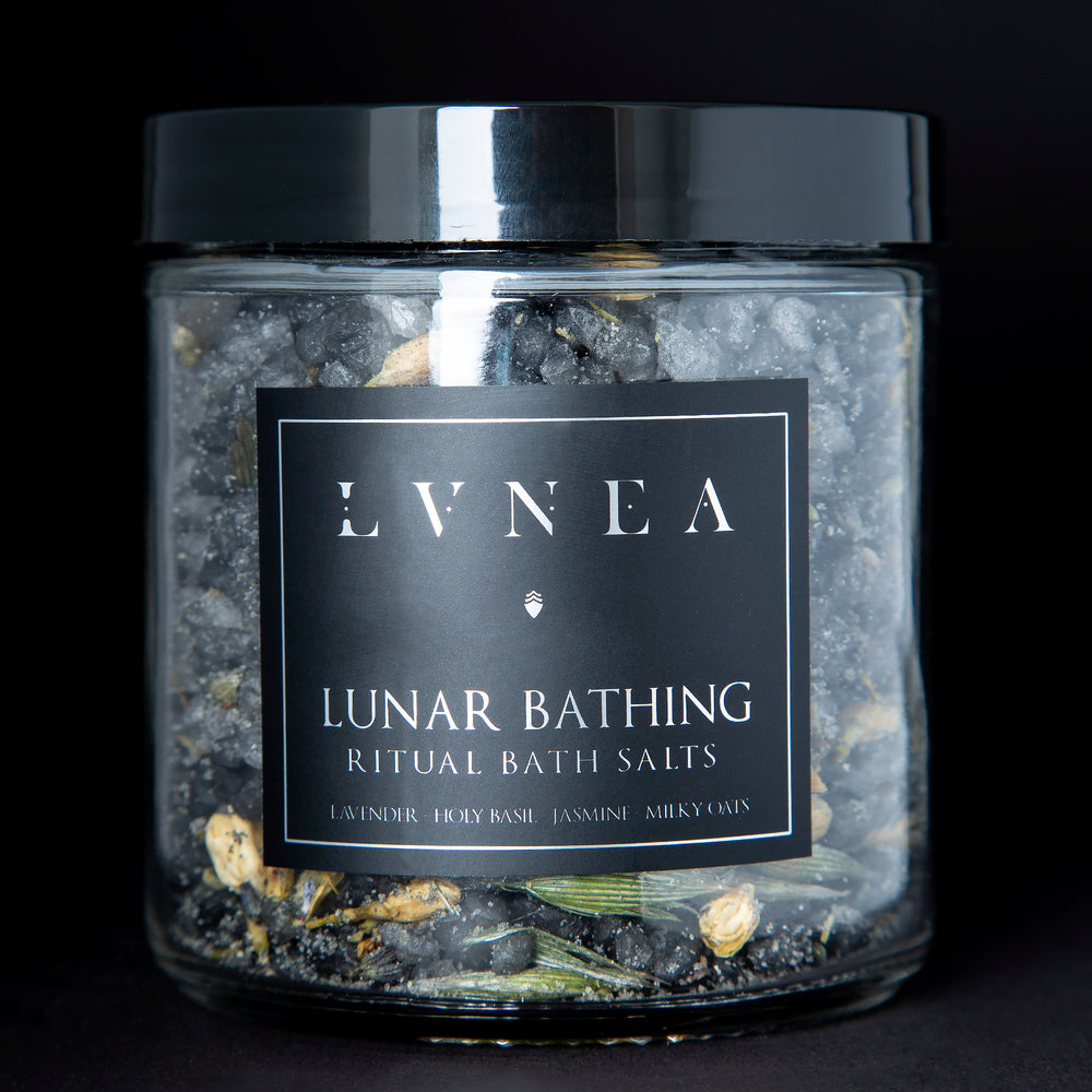A clear 16 ounce jar filled with LVNEA's Lunar Bathing bath salts on black background