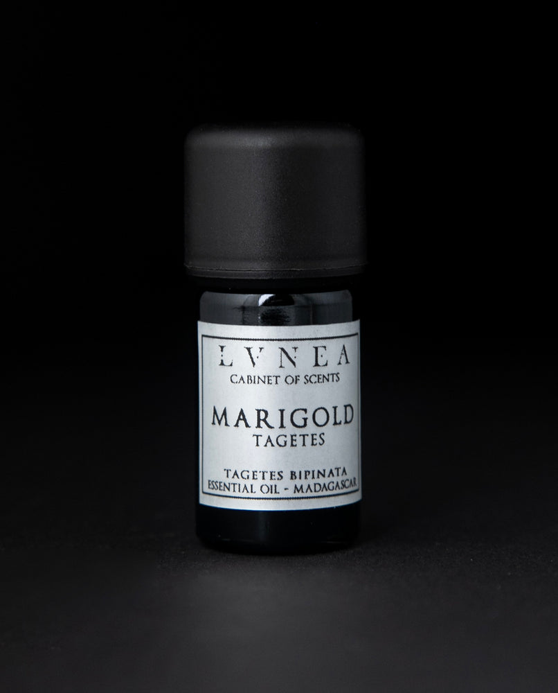 5ml black glass bottle of LVNEA's marigold essential oil on black background. The label on the bottle is silver.