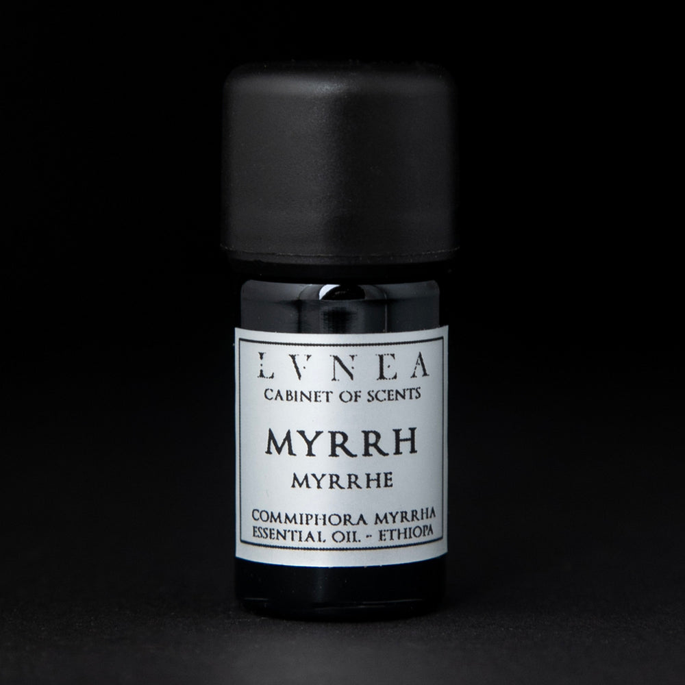 5ml black glass bottle of LVNEA's myrrh essential oil on black background. The label on the bottle is silver.
