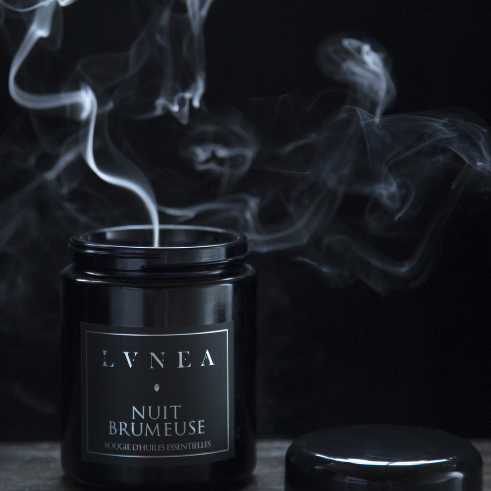 8 oz Nuit Brumeuse candle with lid removed. A plume of smoke is rising from the candle.